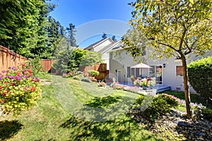 Backyard with lanscape and walkout deck with patio area