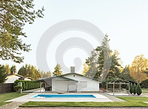 Backyard of a modern white house with a swimming pool. House outside the city. Space for text