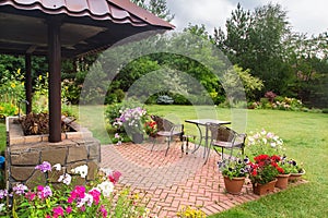 Backyard Patio Area with Fireplace and Furniture. Green Party area.