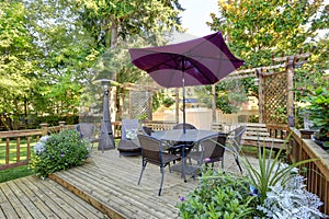 Backyard patio area with outdoor wicker furniture