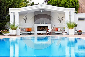 Backyard patio of a luxury residance with swimming pool and fireplace