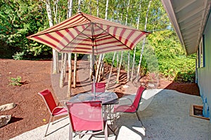 Backyard Patio With Red Striped Umbrella