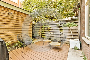 a backyard patio with two chairs and a table on