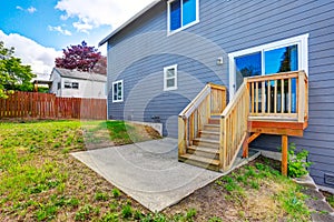 Backyard with small concrete patio area and stairs