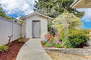 Backyard small shed and flower bed view