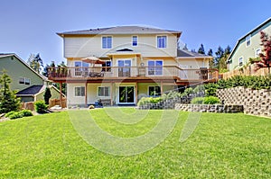 Backyard of three story house with fenced yard.