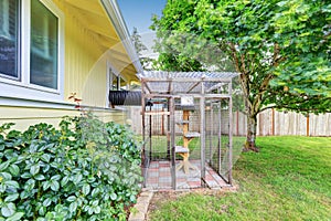 Backyard view with cat's cage with beware sign