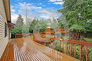 Backyard view of a spacious two story home with walk out deck