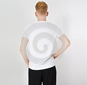 Bacl view white tshirt on a young man isolated. Ready for your design