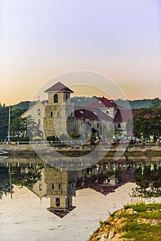 Baclayon Church at Sunset. Reflective water mirrors the church. photo