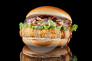 Bacon cheeseburger hamburger isolated on black. BBQ sauce and lettuce. Beautiful black mirror background.