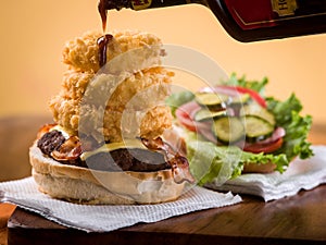 Bacon cheeseburger with stack of onion rings