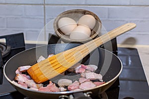 Bacon fried in a pan like the basis of good scrambled eggs.