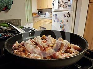 Bacon in frying pan or skillet in kitchen