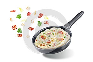 Bacon garlic parsley pasta in a black pan on a white isolated background