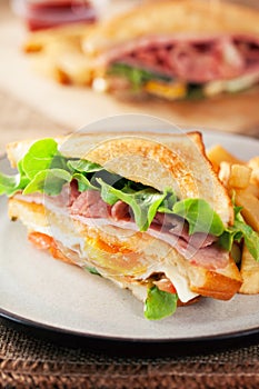 Bacon and ham sandwich with french fries