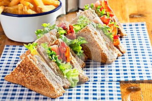 Bacon lettuce tomato sandwich with spring onion mayo and fries