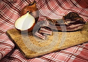 Bacon with onion on wooden board