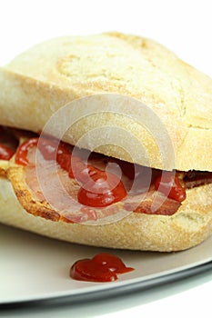 Bacon roll and tomato ketchup.