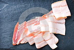 Bacon slices on the dark background