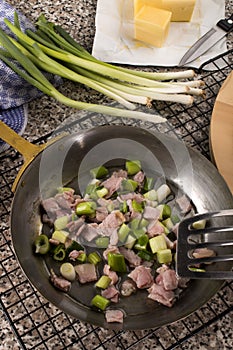 Bacon and spring onion in a pan