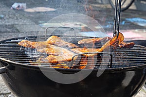 A bacon steak being prepared on the bbq