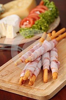 Bacon wrapped grissini and cheese photo