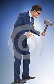 Bad angry boss threatening employee with hammer