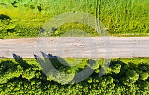 Bad asphalt road with large holes top view, federal highway of the Vologda and Kostroma regions in the north of Russia