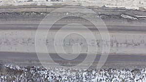 Bad asphalt road with large holes top view, federal highway of the Vologda and Kostroma regions in the north of Russia