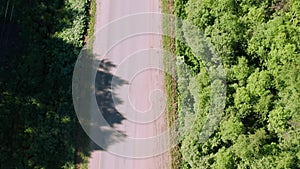 Bad asphalt road with large holes top view, federal highway of the Vologda and Kostroma regions in the north of Russia