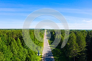 Bad asphalt road with large holes top view, federal highway of the Vologda and Kostroma regions in the north of Russia