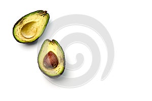 A bad avocado cut in half on white background