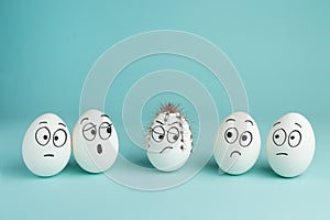 Bad character concept. Prickly egg. Five white eggs with drawn faces on a blue background