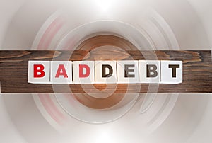 Bad debt Words on wooden cubes on old wooden table. Business, finance concept