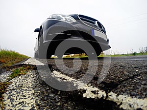 Bad, destructed road and car