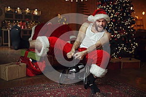 Bad drunk Santa claus riding on little toy car