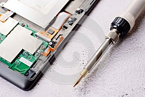 Bad electrical circuit being repaired by a technician with a tin soldering iron