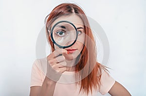 Bad eyesight. A woman's face through a magnifying glass. Long hair, big eyes. Research, choice concept