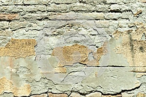 Bad foundation base on old house or building cracked plaster facade wall with brick background