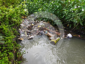 Garbage polluting waterways in ditch photo