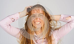 Bad hairs day. Young woman with long disheveled damaged hair. Haircare. Woman having bad messy and tangled hair. Female