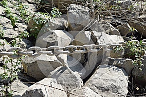 Bad Honnef, Germany - 09 08 2021: shore rocks with a chain