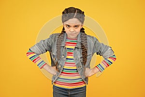 In bad humor. Moody little child yellow background. Little baby wear braided hairstyle. Little girl in casual style