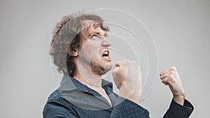 Bad man expressing anger with face and hands photo