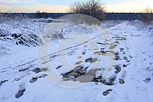 Bad muddy winter road. Beautiful winter landscape.