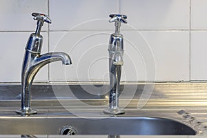 Bad plumbing. Badly fitted sink tap. Faucet with limescale