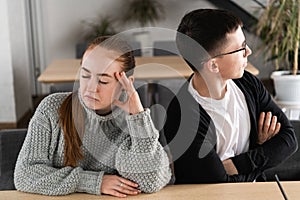 Bad relationship concept. Man and woman in disagreement. Young couple after quarrel sitting next to each other. Outdoor