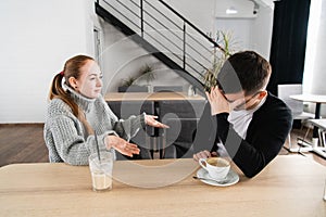 Bad relationship concept. Man and woman in disagreement. Young couple sitting in cafe having quarrel, offended wife and