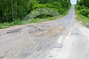 bad road for cars, broken track surface, cracked asphalt